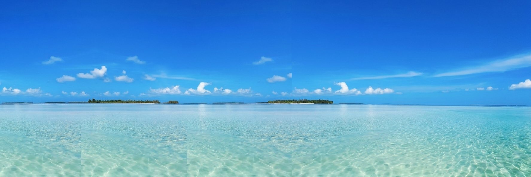 Clear turquoise water and a distant island under a blue sky, Florida Keys