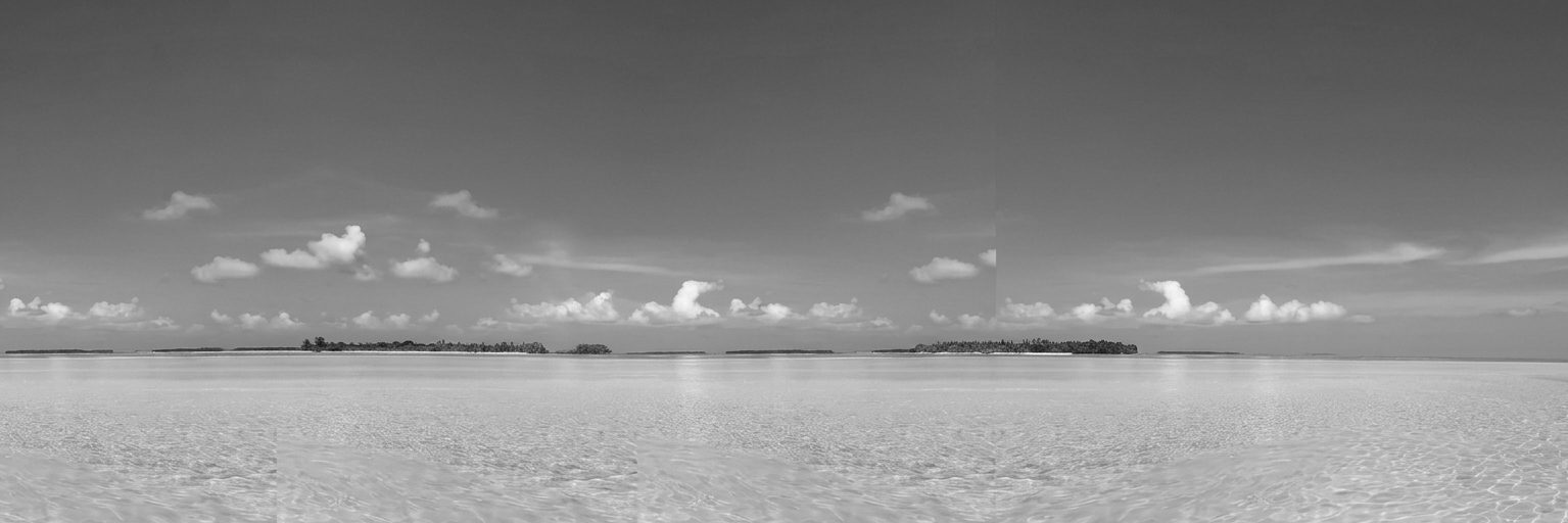 Monochrome panorama of clear water and a distant island under a wide sky, Florida Keys